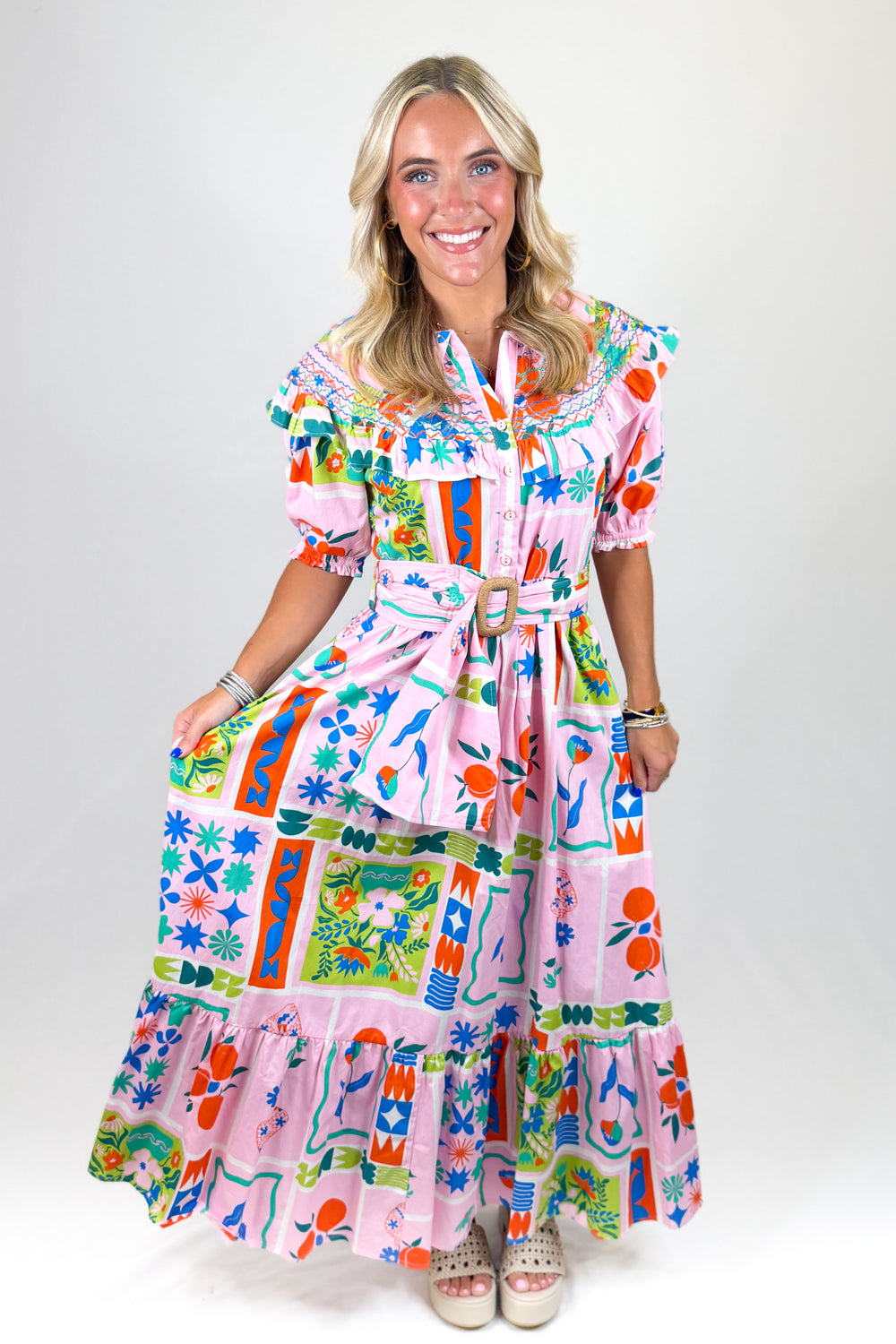 Woman wearing a colorful patterned dress on a white background