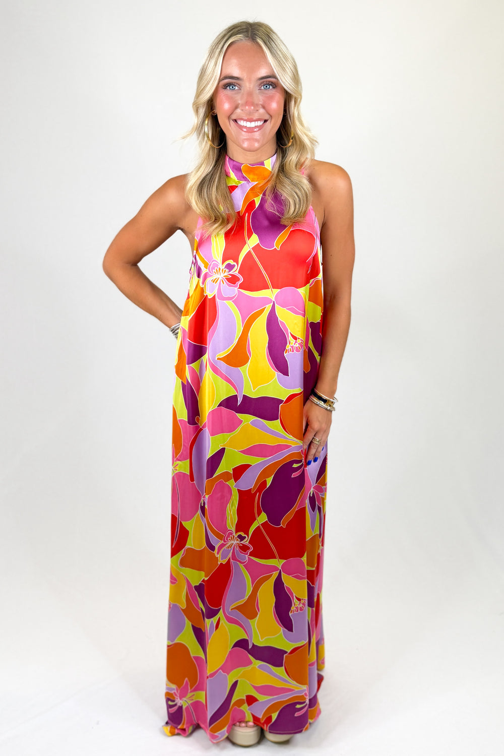 Woman wearing a colorful floral dress on a white background