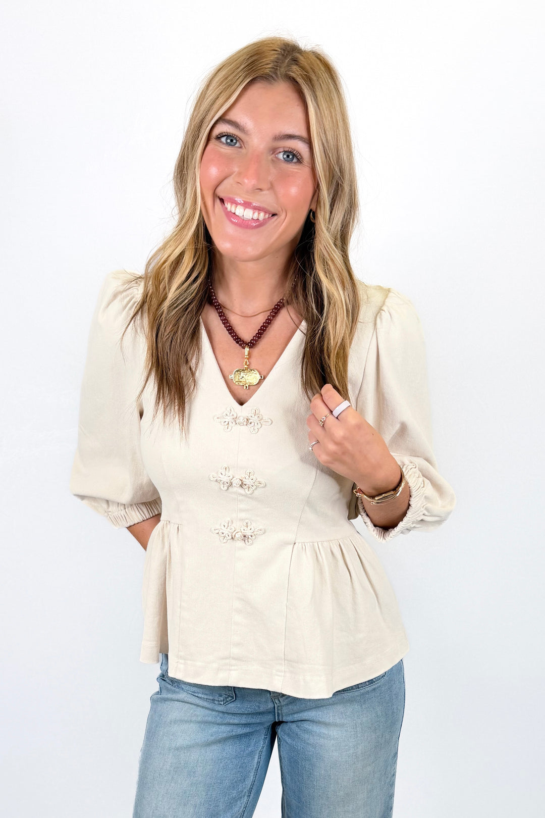 CREAM DETAIL BUTTON VNECK PEPLUM TOP