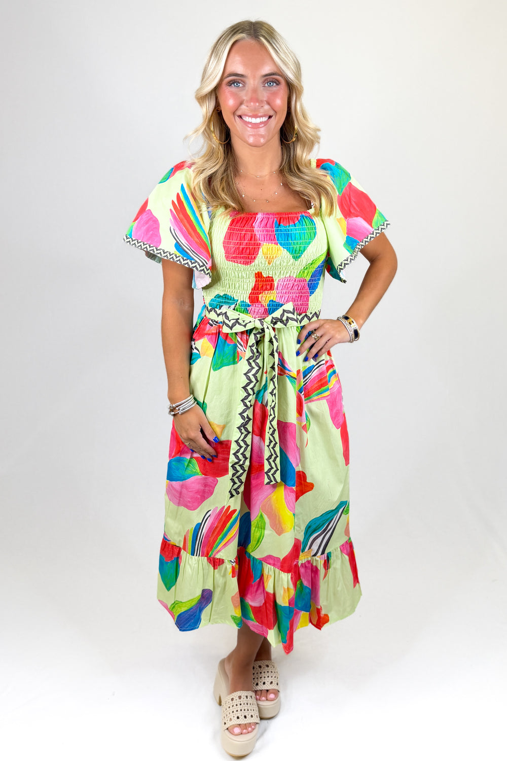 Woman wearing a colorful dress on a white background