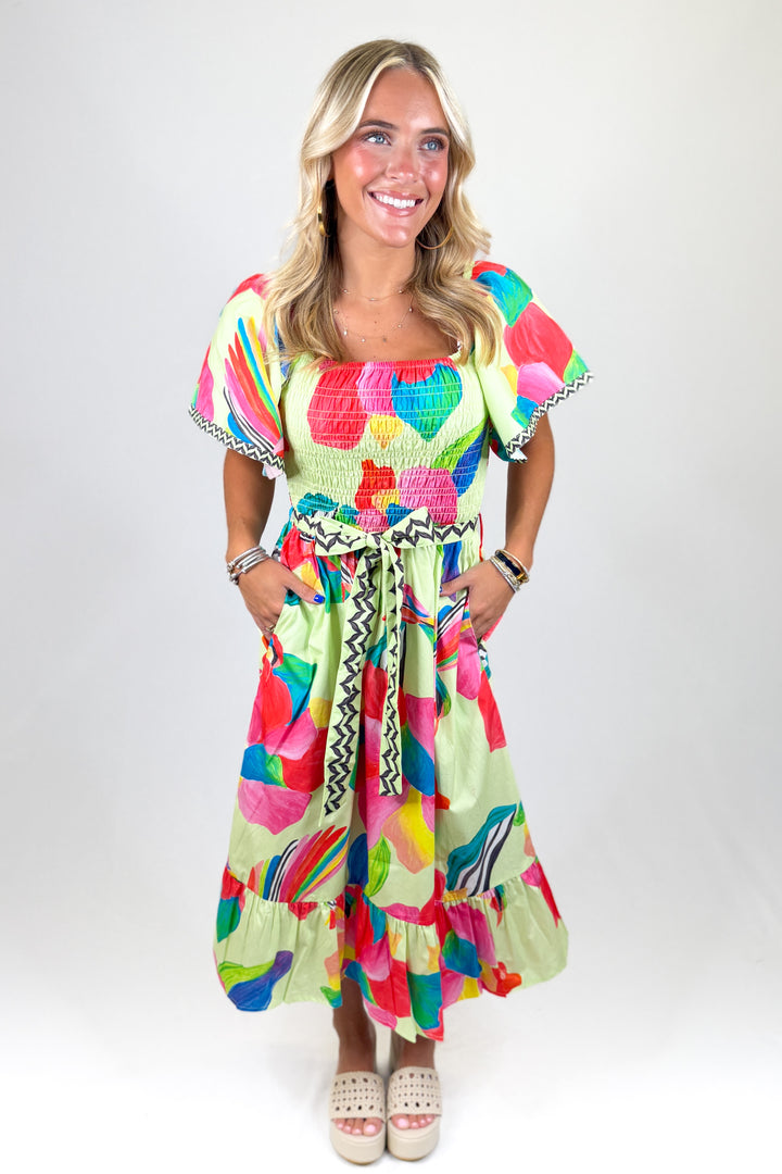 Woman wearing a colorful dress with a white background