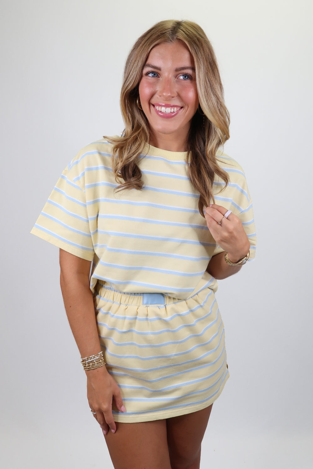 woman wearing a blue and yellow stripe set on a solid background