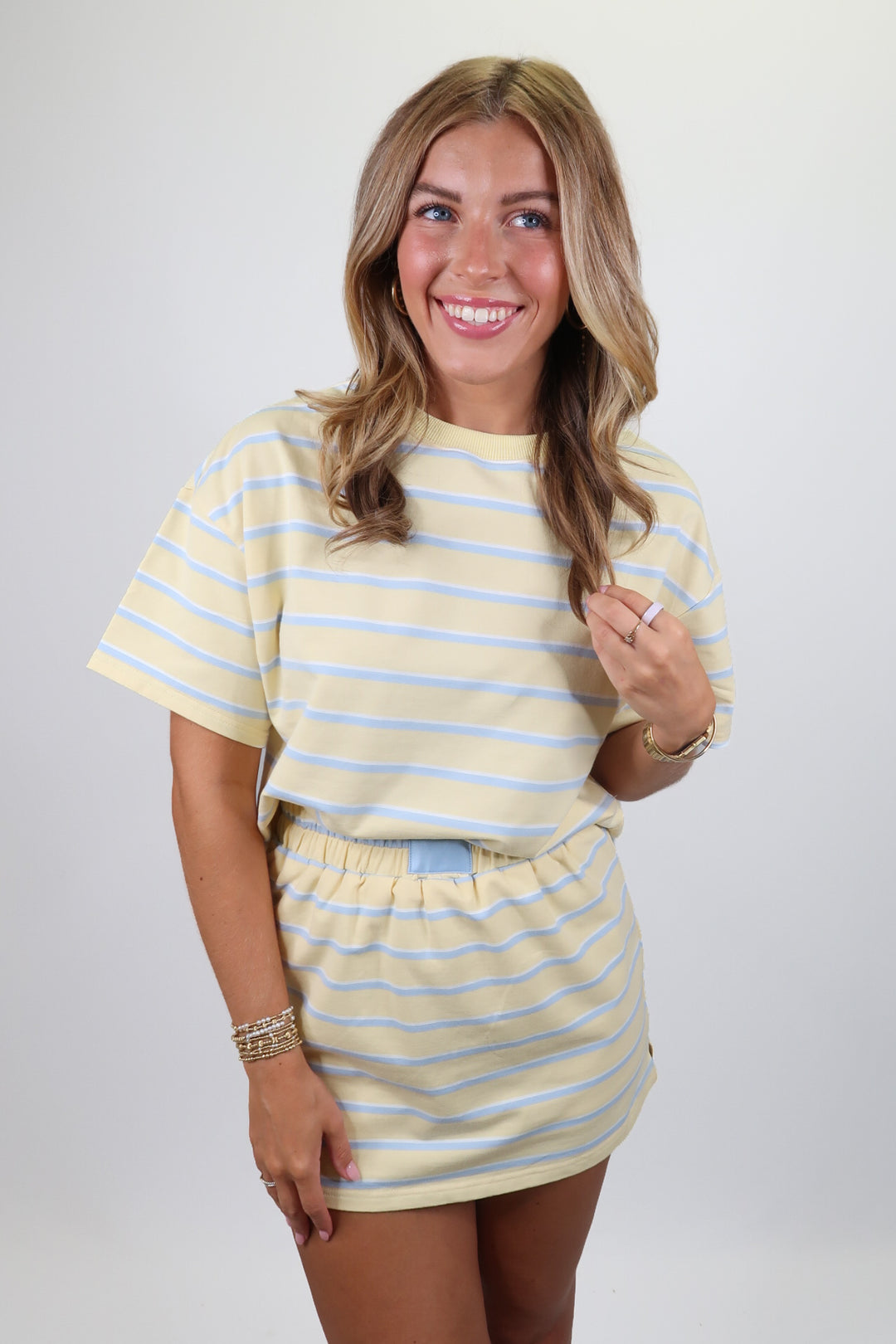 woman wearing a blue and yellow stripe set on a solid background