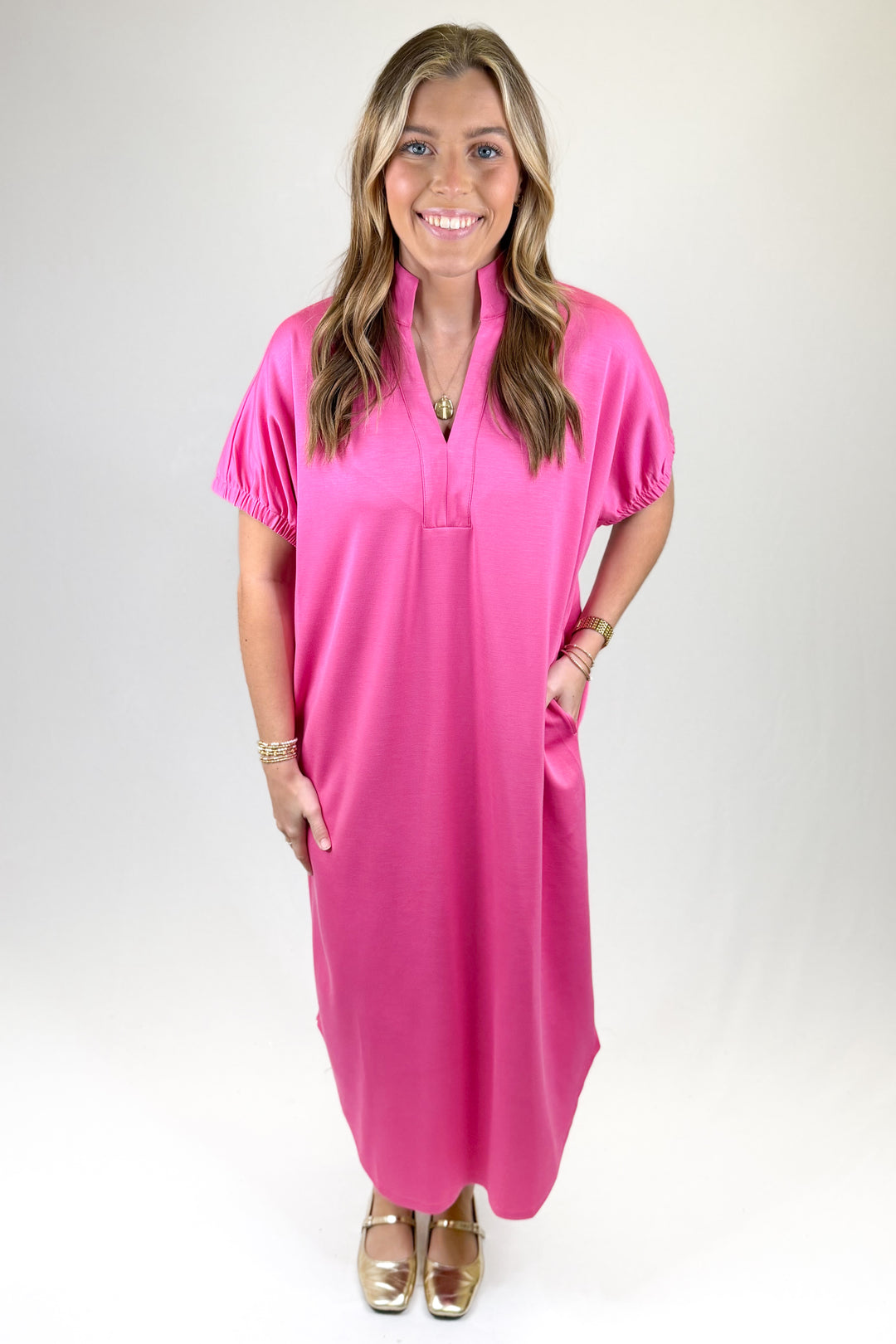 Woman wearing a pink dress against a white background