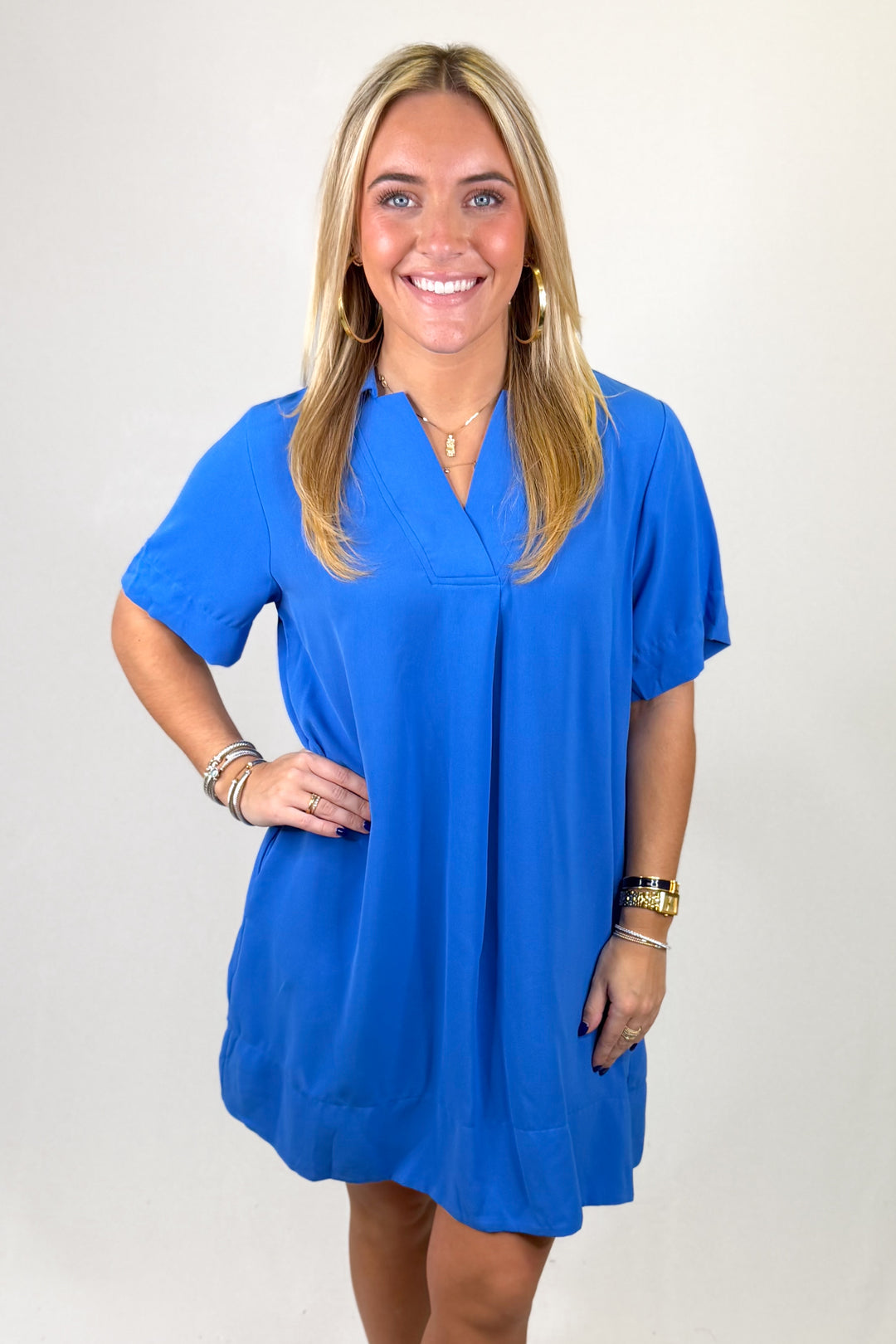 Woman wearing a blue dress against a plain background