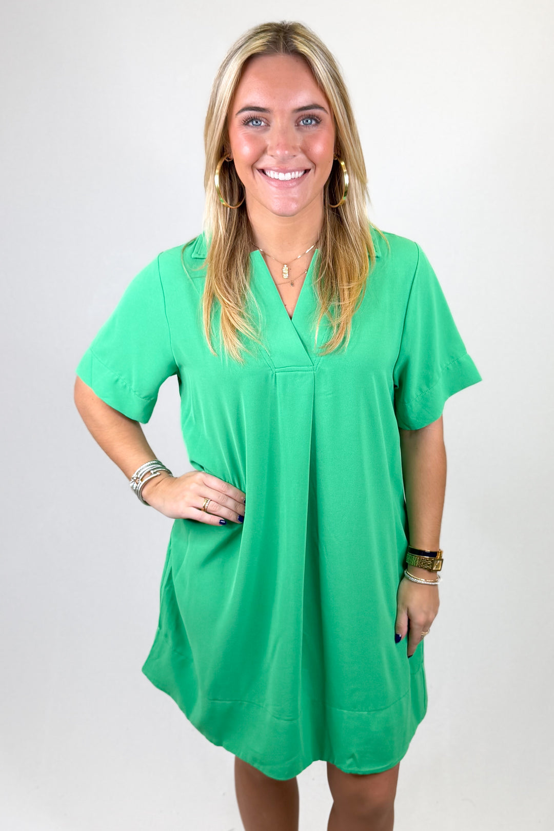 Woman wearing a green dress against a white background