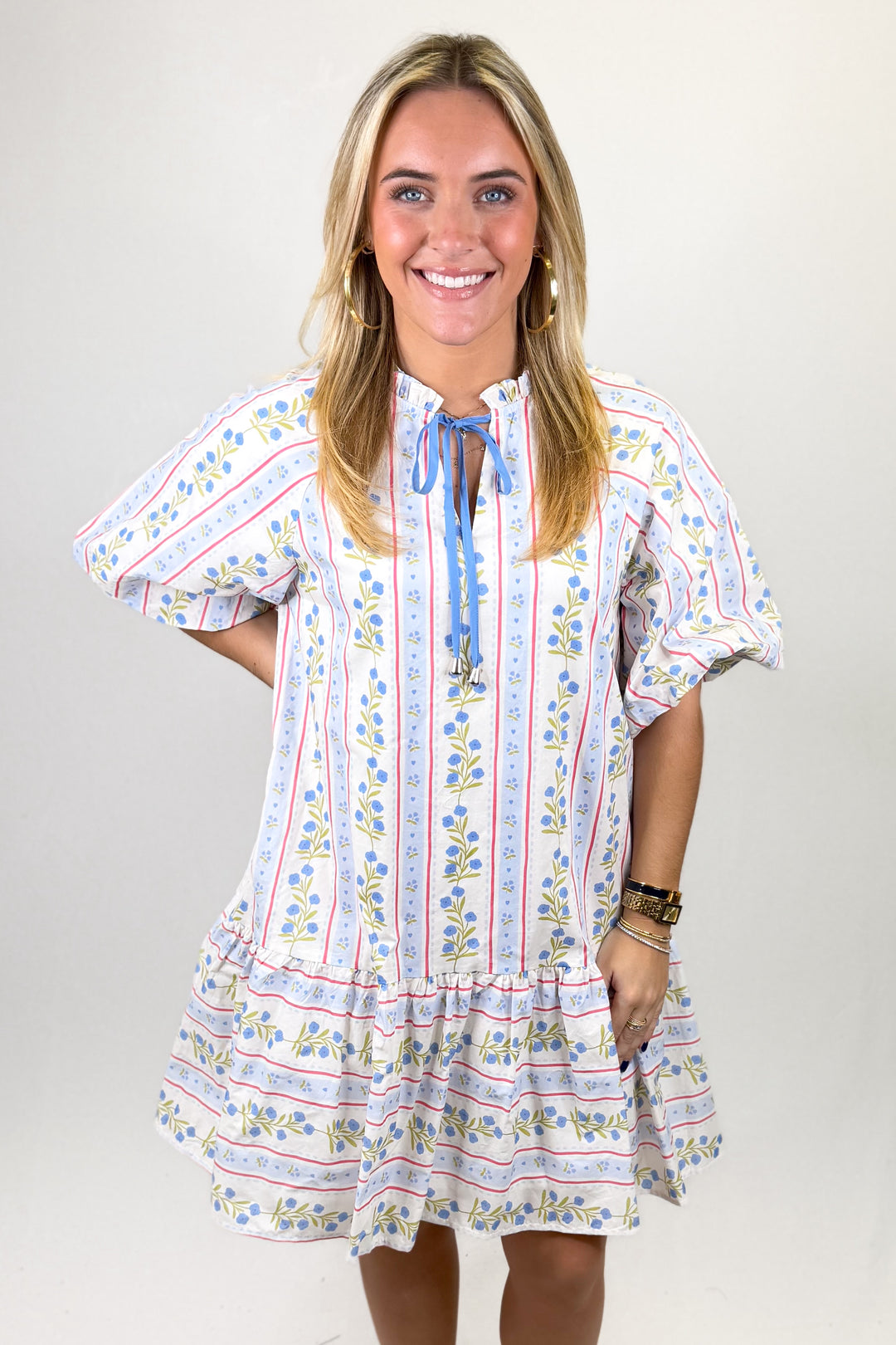 Woman wearing a patterned dress with a plain background