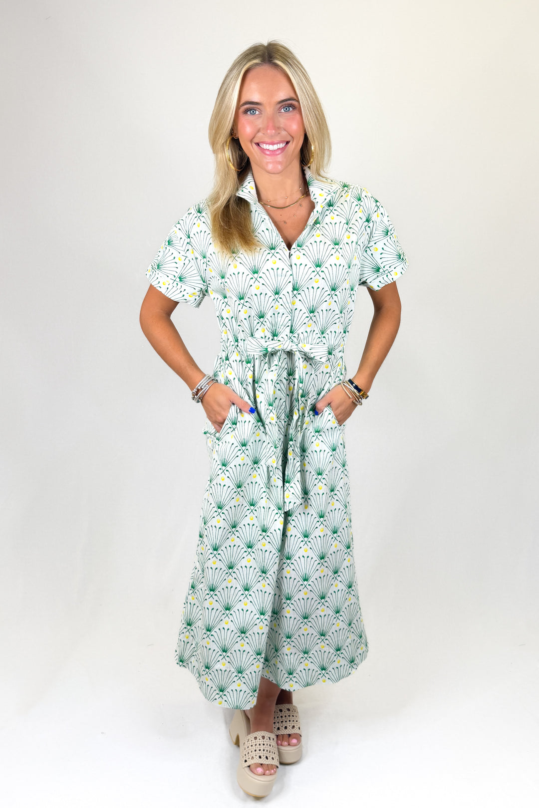Woman wearing a golf club printed dress on a white background