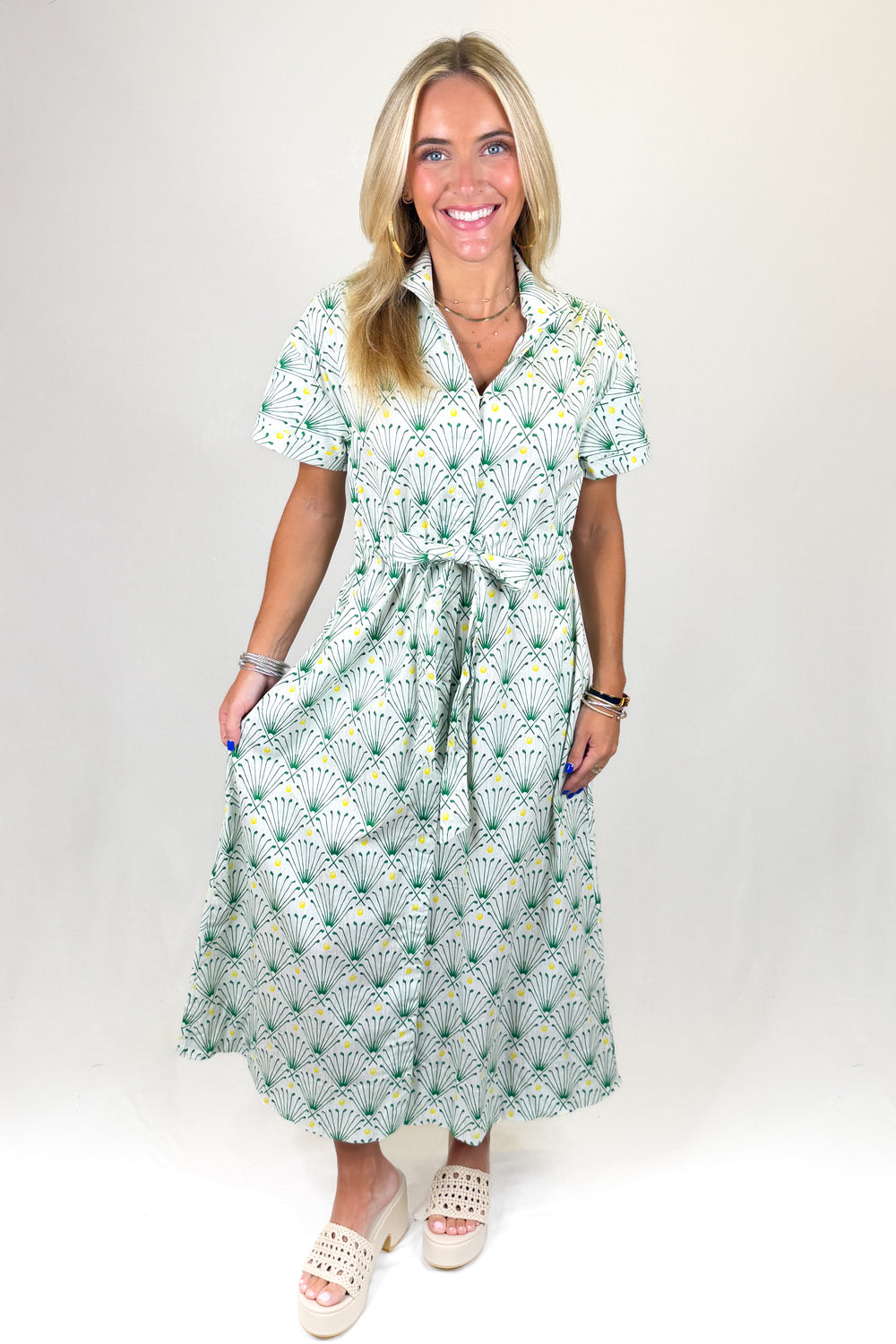 Woman wearing a golf club printed dress on a white background