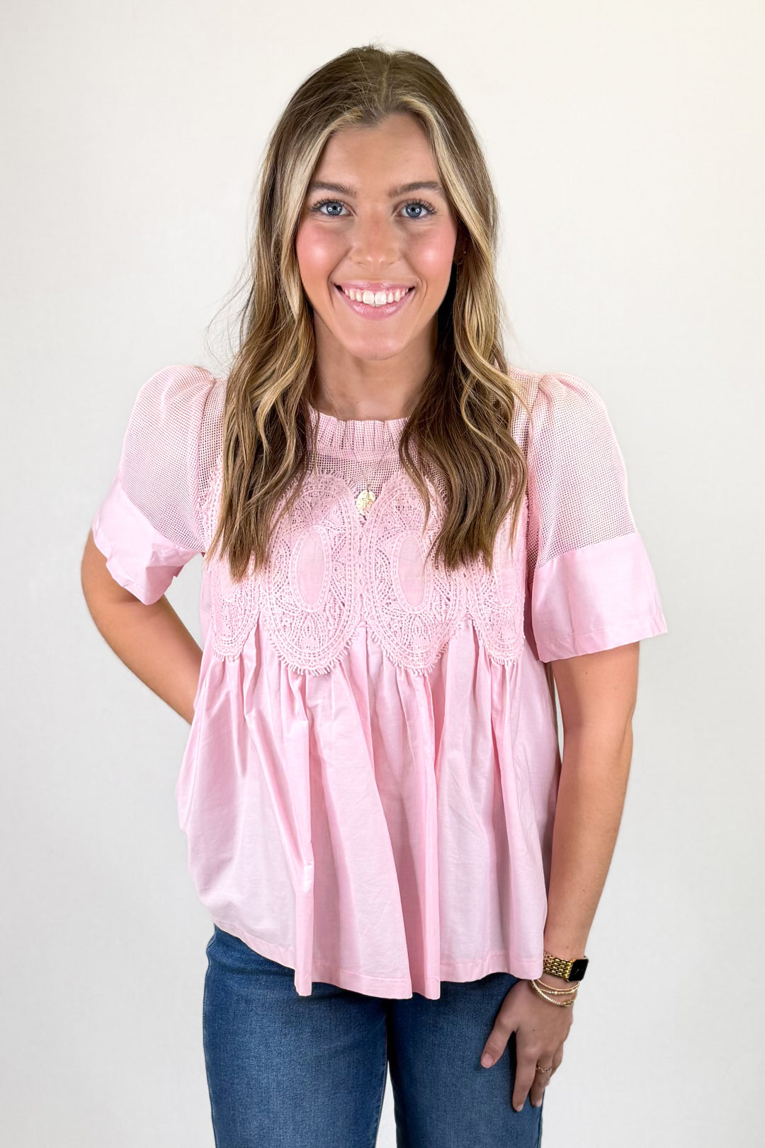 pink top with mesh accent on woman