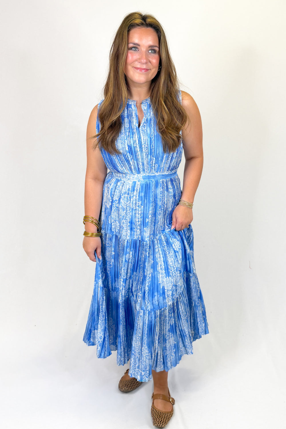 Woman wearing a blue patterned dress on a white background