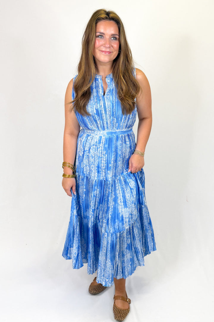 Woman wearing a blue patterned dress on a white background
