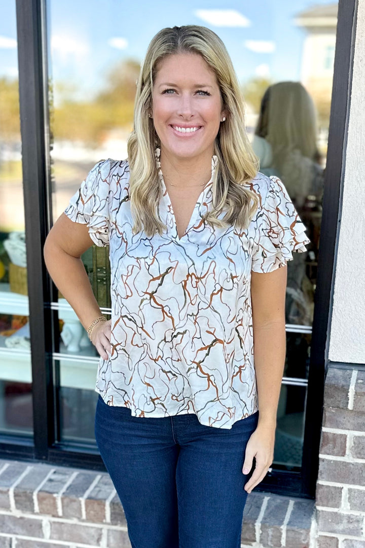 RUST & IVORY SWIRL PRINT VNECK TOP