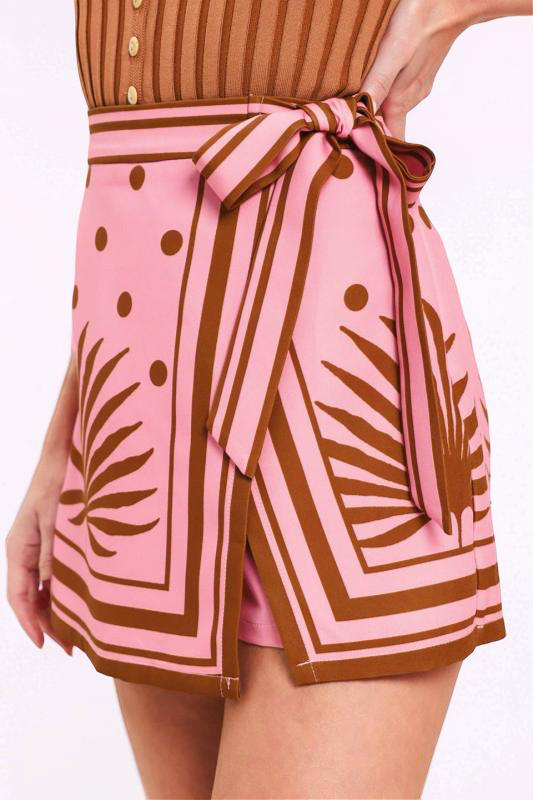 Pink and brown patterned shorts with a tie waist on a white background