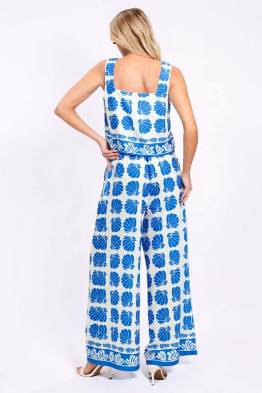 Woman wearing a blue and white patterned set on a white background