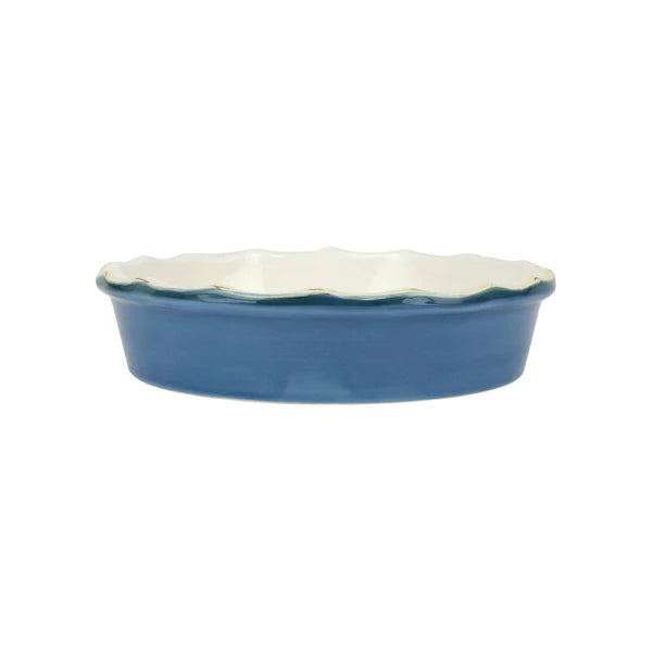 Blue ceramic dish with scalloped edge on a white background