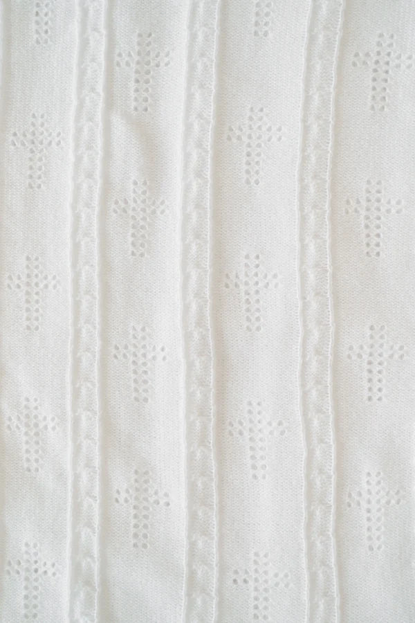 Close-up of a textured white fabric with a subtle pattern