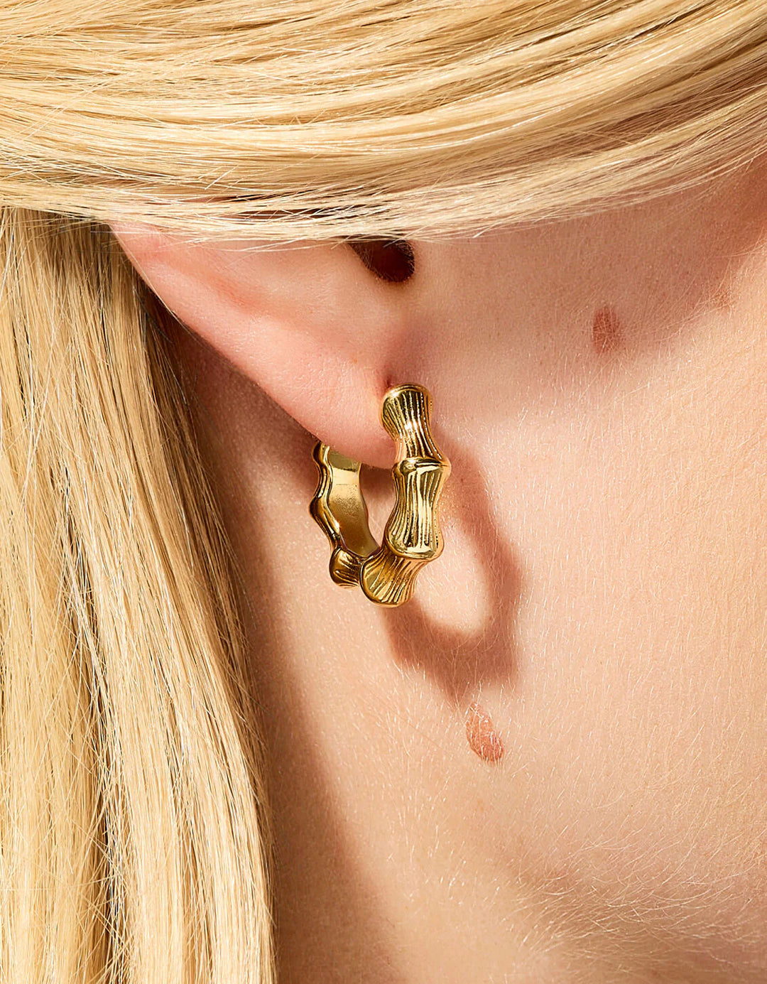 BAMBOO STYLE GOLD HOOP EARRINGS SHOWN ON MODEL
