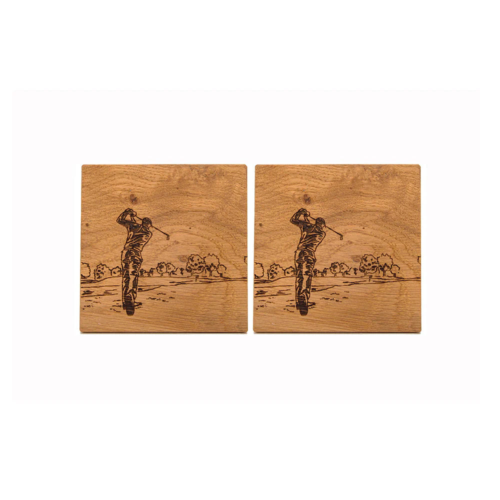 Two wooden coasters with engraved images of a golfer on a white background