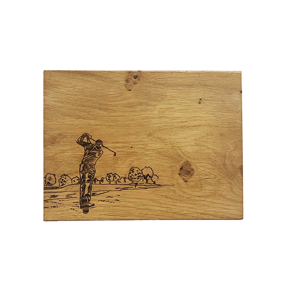 Wooden plaque with a laser-engraved image of a golfer on a golf course.