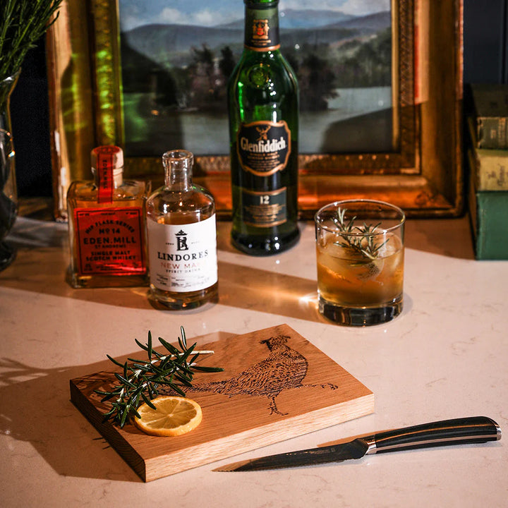 Alcohol bottles and a cocktail on a table with a scenic background