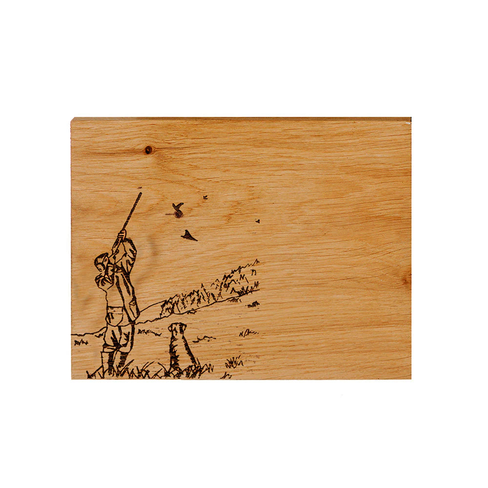 Wooden cutting board with engraved design of a person and birds on a white background