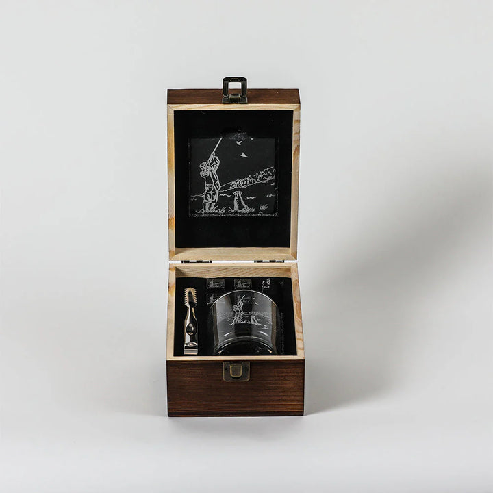 Wooden gift box with engraved glass and accessories on a white background
