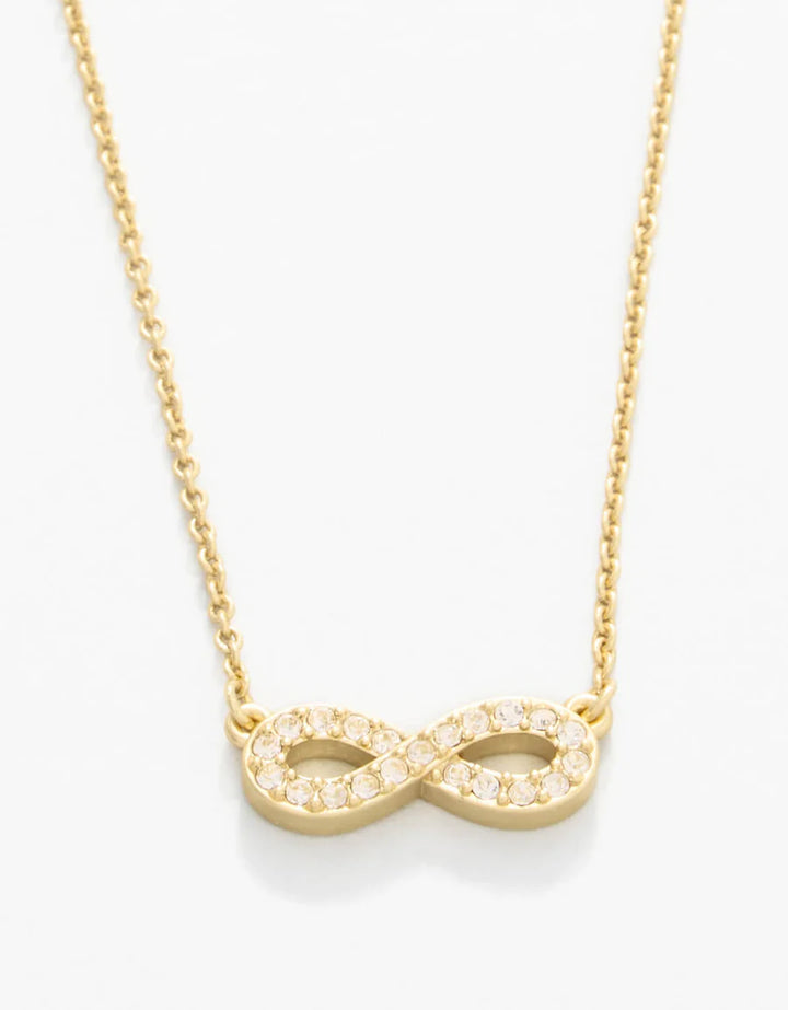 Gold infinity necklace on a white background