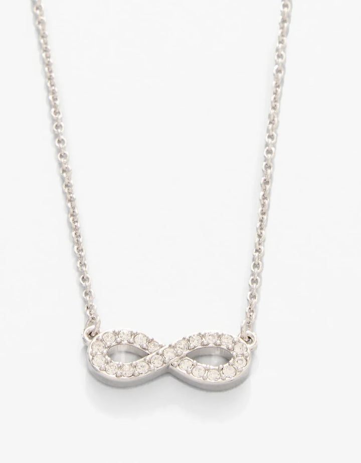 Silver infinity necklace with clear stones on a white background