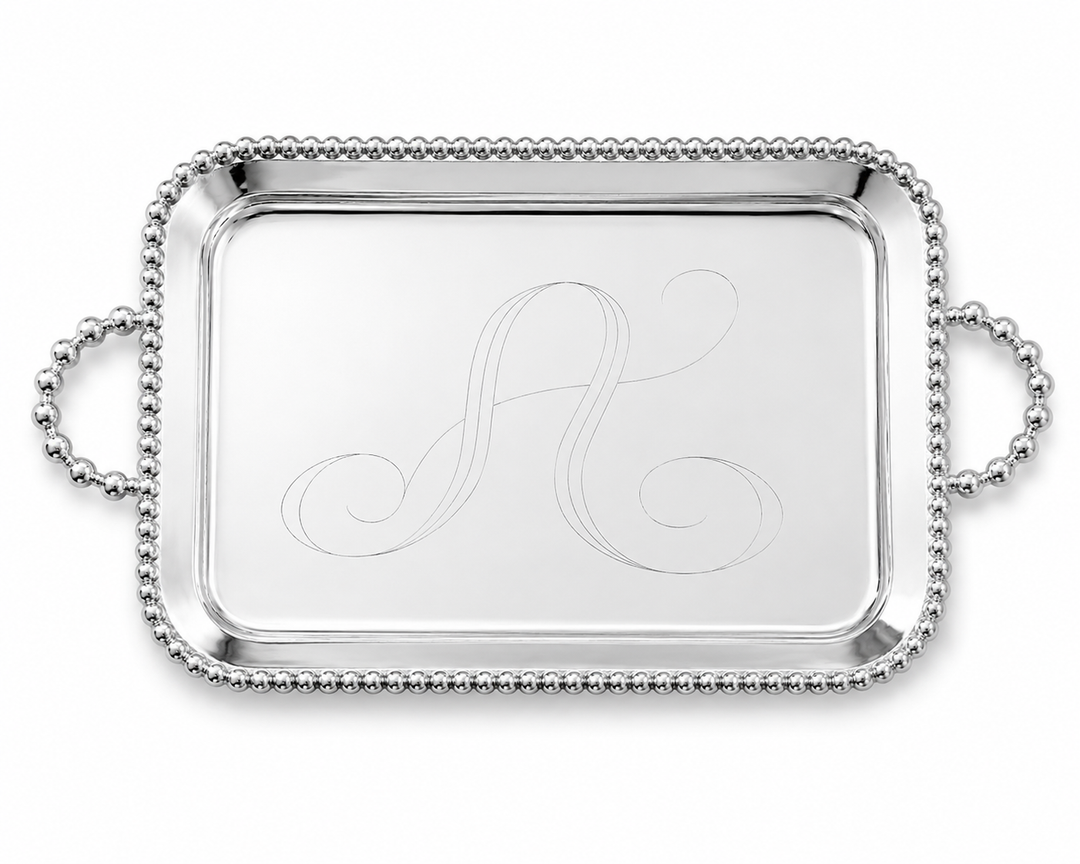 Silver tray with monogram 'A' on a white background