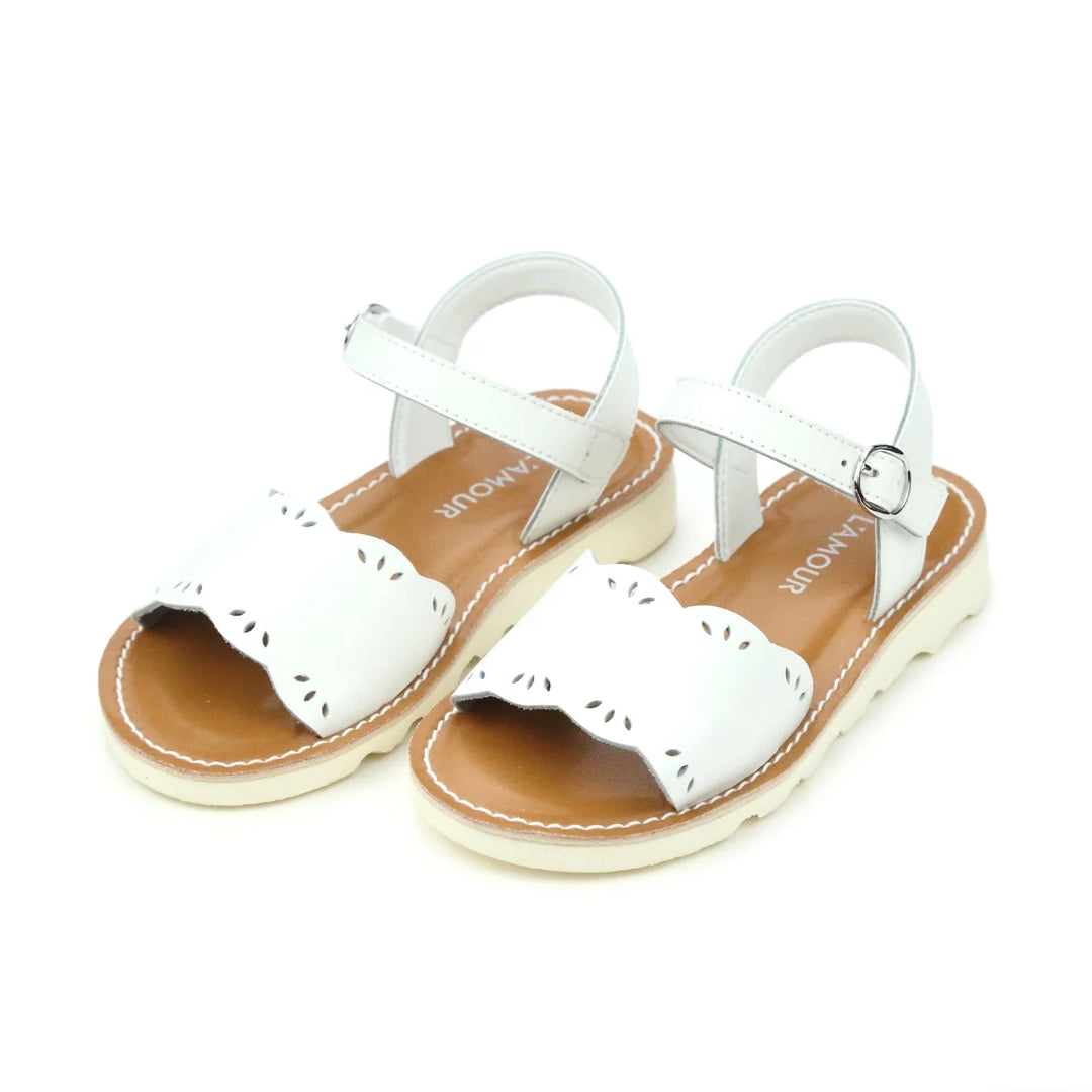 White sandals with brown soles on a white background