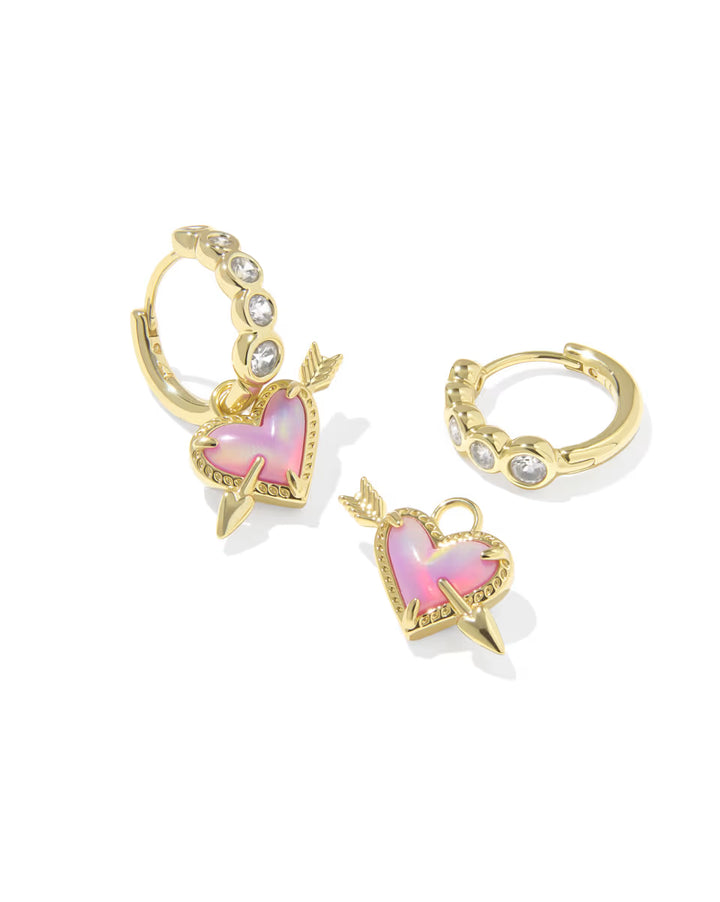 Gold heart-shaped earrings with pink gemstones on a white background