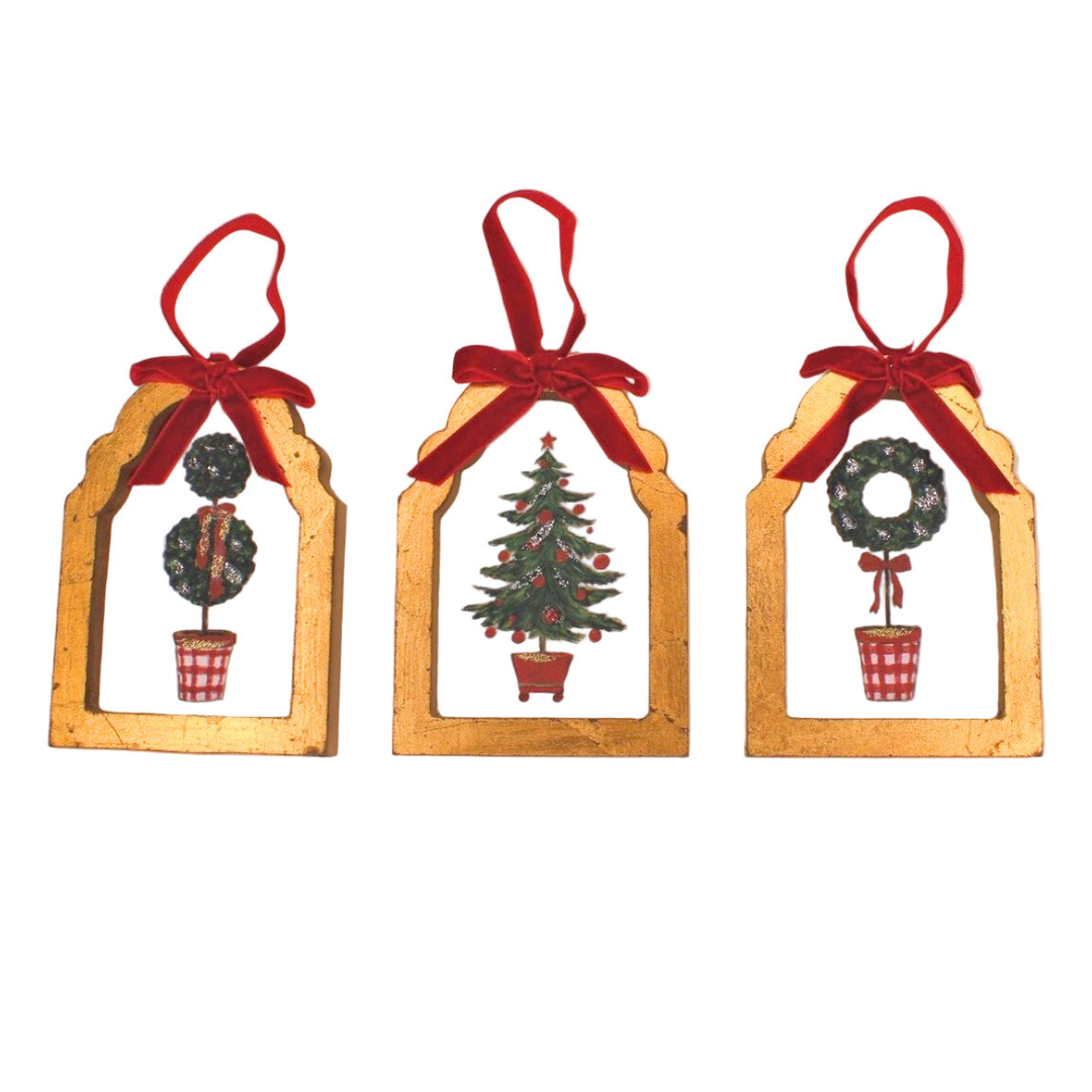 Three Christmas-themed window decorations with red ribbons on a white background