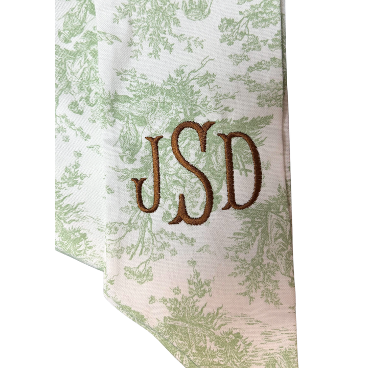 Floral patterned fabric with embroidered initials 'JSD' on a white background