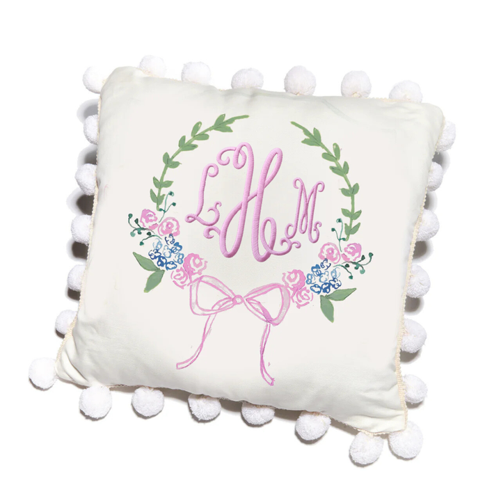 pillow with wreath and bow design and personalized with matching pink initials in center