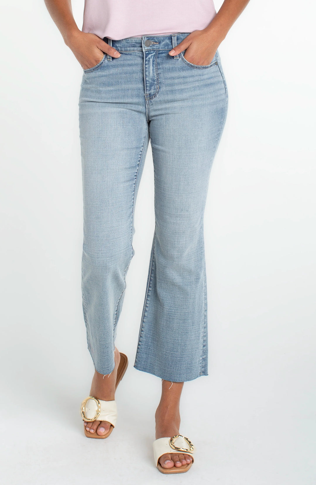 Light wash cropped flare jeans with raw hem, high-rise fit, and subtle stretch,