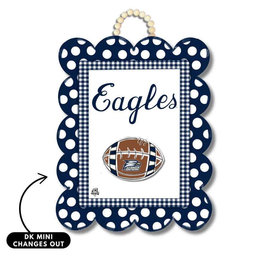 A personalized Georgia Southern Eagles themed mini wall sign with a navy blue and white polka dot frame, a gingham inner border, the word 'Eagles' in script, and a football graphic featuring the Eagles logo. A hanging loop is at the top, and a black arrow with text 'DK MINI CHANGES OUT' indicates a customizable insert.
