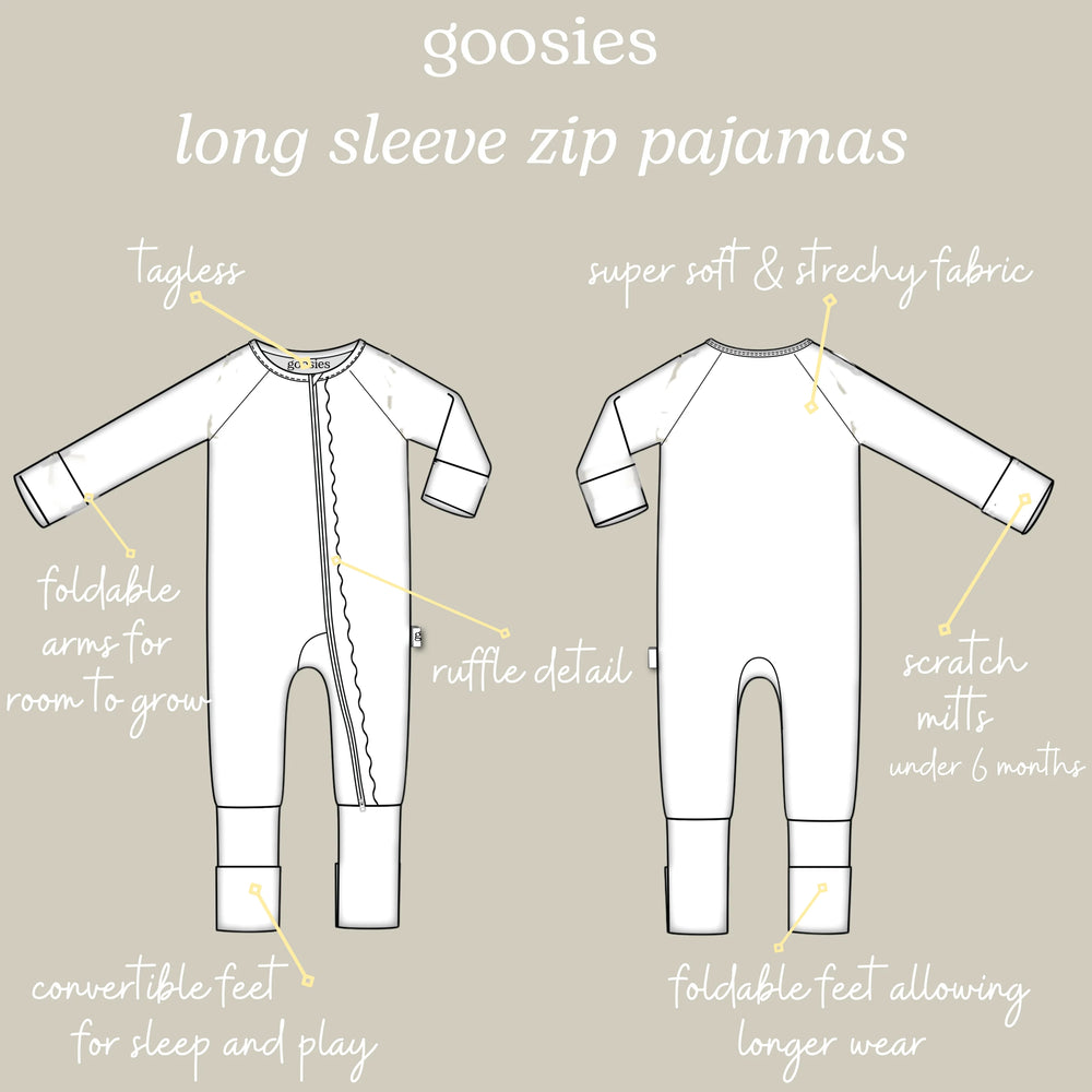 A product information graphic showing front and back line drawings of white long-sleeve zip pajamas with handwritten callouts and labels on a light beige background.