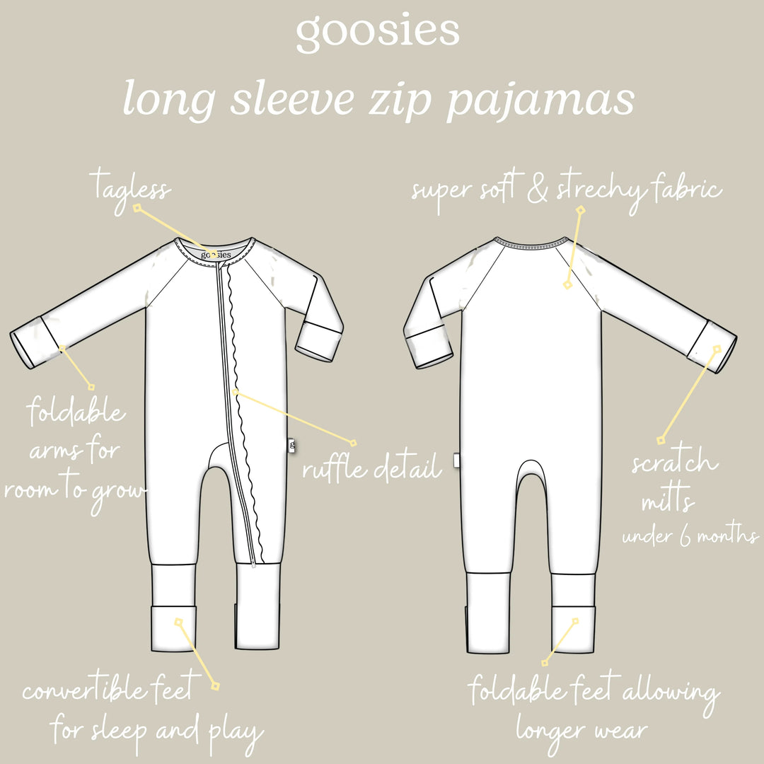 A product information graphic showing front and back line drawings of white long-sleeve zip pajamas with handwritten callouts and labels on a light beige background.