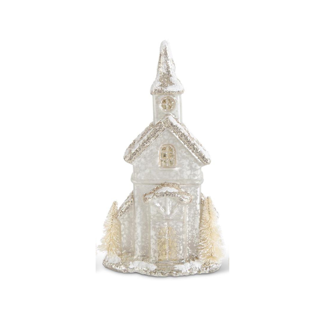 Decorative miniature church with a snowy texture on a white background