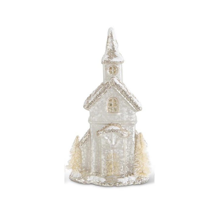 Decorative miniature church with a snowy texture on a white background