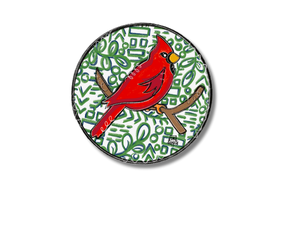 Pin with red cardinal bird design on a white background
