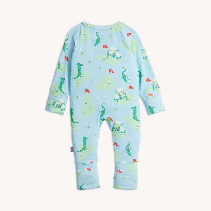 Baby onesie with alligator pattern on a light blue background
