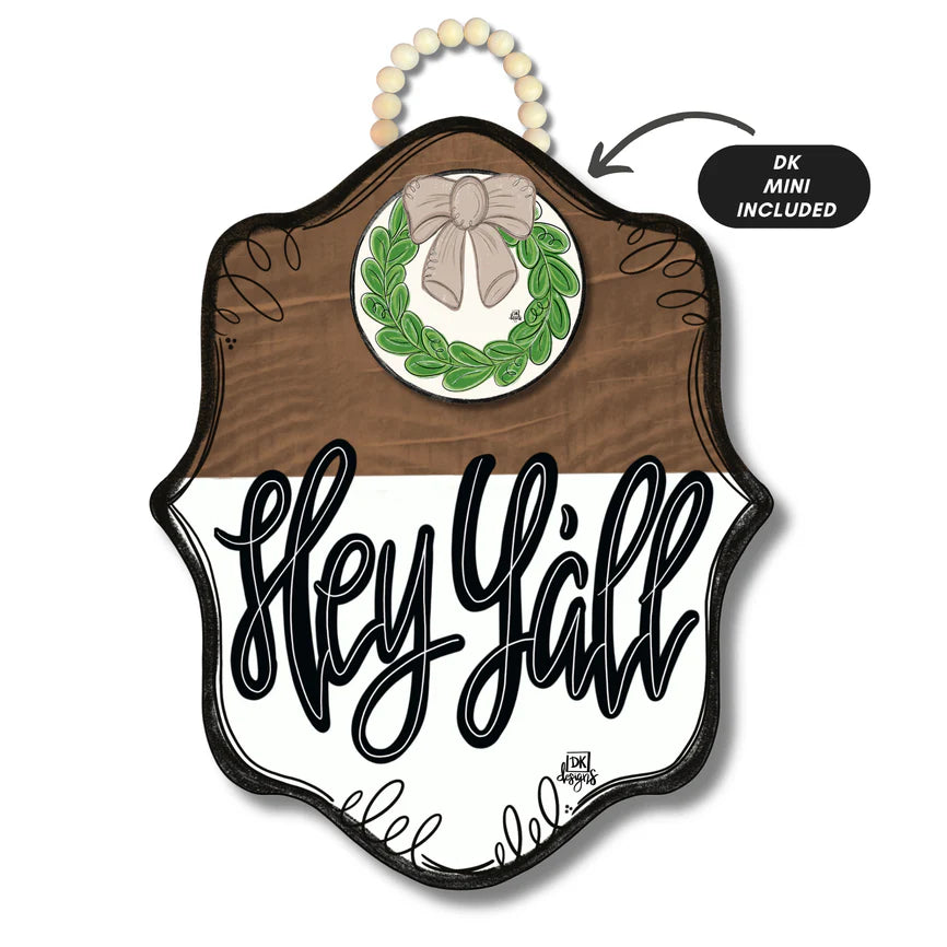 Hey Y’all wooden door hanger with scalloped edge, stained wood top, white background, black script lettering, wreath and bow accent, and bead hanger | Walker Boutique