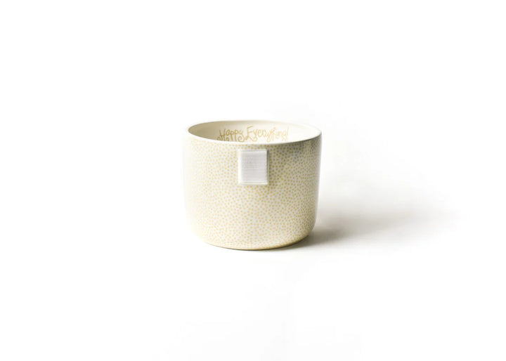 A beige ceramic mini bowl with a small white dot pattern, displayed against a neutral background.