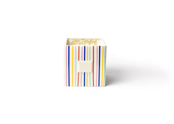 Small rectangular box with colorful striped pattern on a white background
