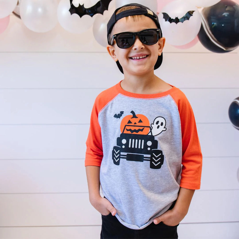 boy wearing jack o lantern tee at party