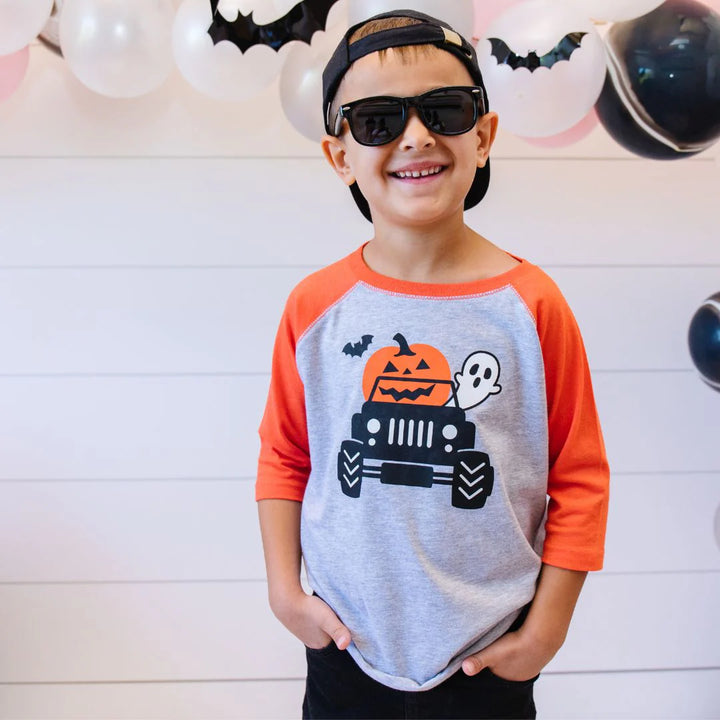 boy wearing jack o lantern tee at party