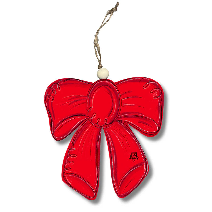 Red bow-shaped ornament with a white bead on a white background