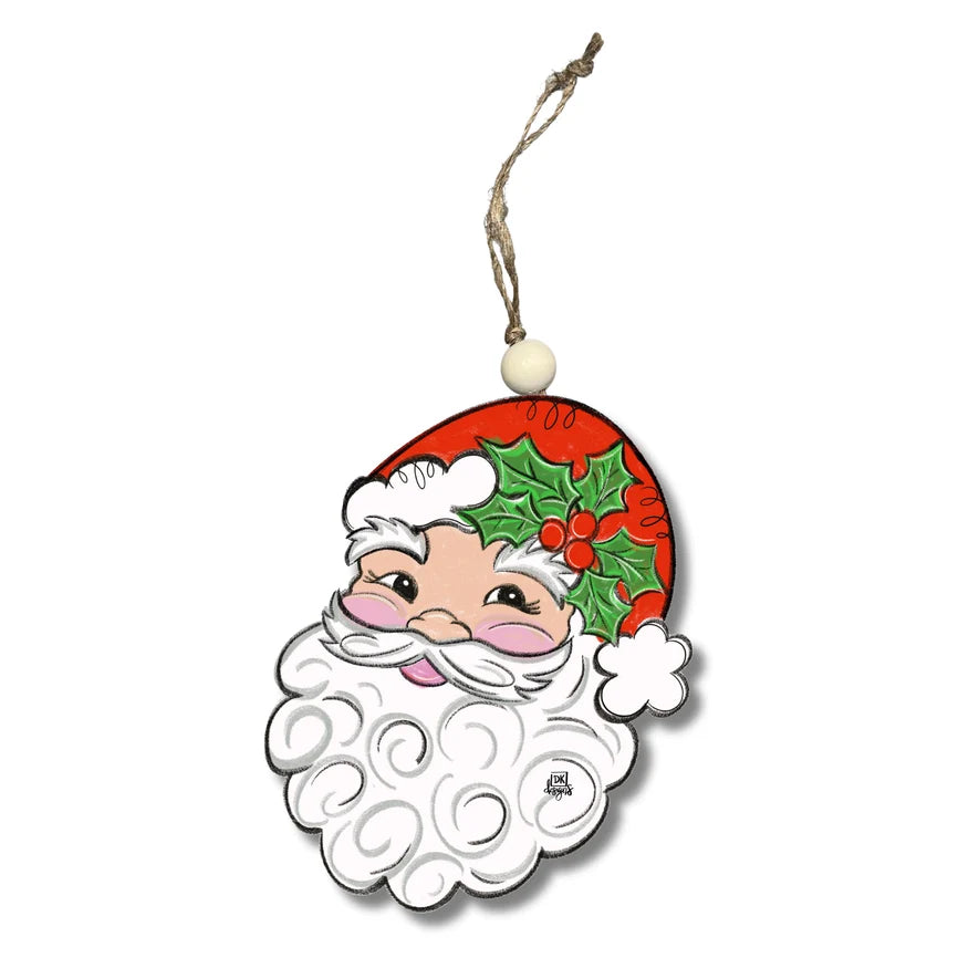 A festive Christmas ornament shaped like a stylized Santa Claus face, featuring a red hat with green holly leaves and red berries, a white beard, and a hanging string with a small white bead at the top, shown on a plain white background.